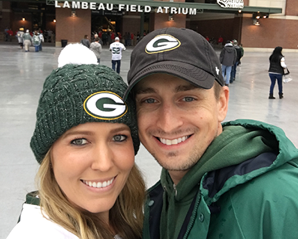 Amy with her husband at a Green Bay Packers game.